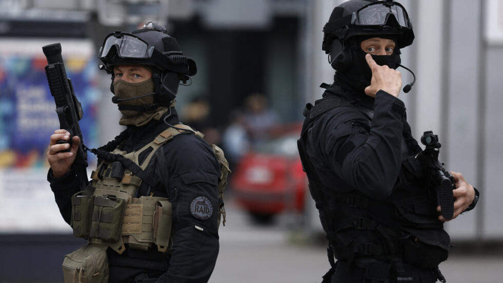 Officers from the RAID (Research, Assistance, Intervention, Deterrence) tactical unit of the French National Police patrol the street in Lille, northern France, on June 30, 2023.